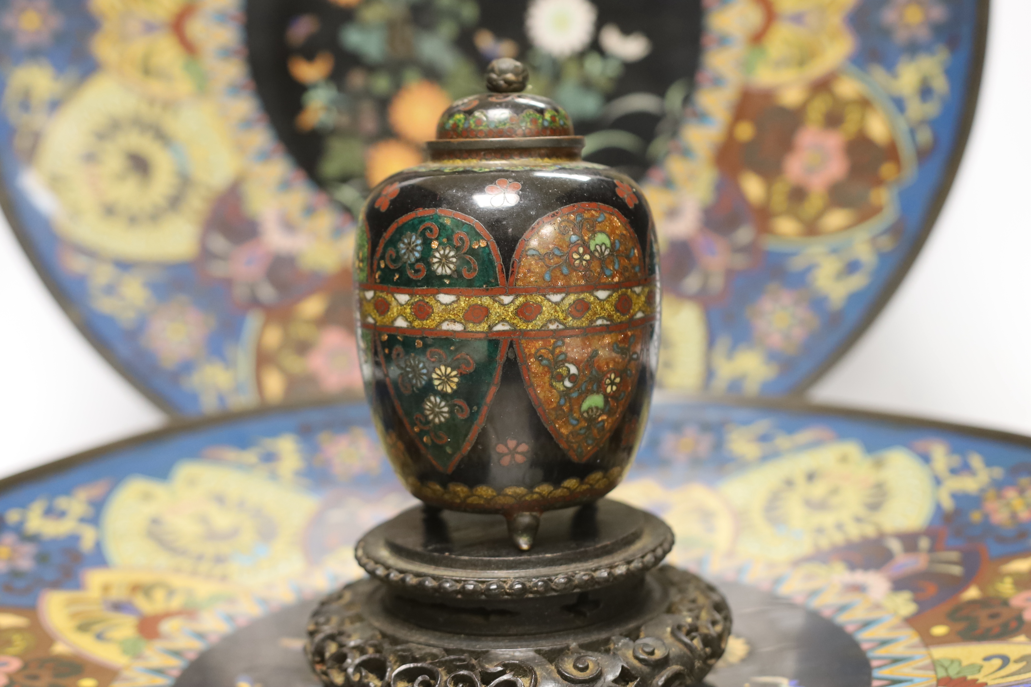 Two Japanese cloisonné enamel chargers and a finer cloisonne jar and cover on stand, largest 46cm (2)